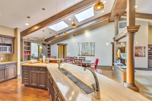 a kitchen with wooden cabinets and a dining room at The Chateaux Deer Valley in Park City