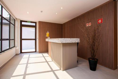 an office lobby with a counter and a plant at GoÁtica Aeroporto Congonhas in Sao Paulo
