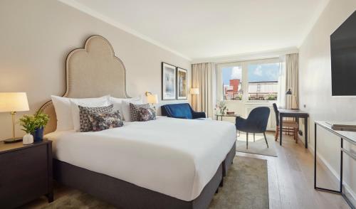 a hotel room with a large bed and a desk at Hôtel Reisen in The Unbound Collection by Hyatt in Stockholm