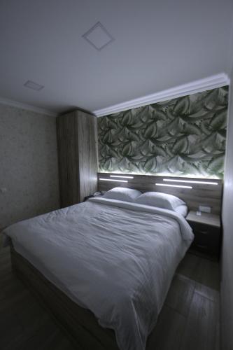 a bedroom with a large bed with a window at Opera Avenue Hotel in Yerevan