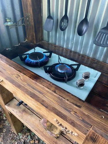 a stove with two pans on top of it at The Hobbit House and Secret Garden in Taunton