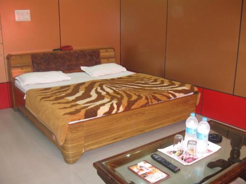 a bedroom with a bed with a tiger printed bedspread at Hotel Shiv Ganga in Rishīkesh