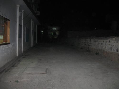 a dark room with a concrete floor and a building at Hotel Shiv Ganga in Rishīkesh