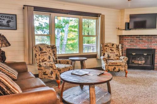 a living room with a couch and chairs and a fireplace at Lost Lake Lodge in Nisswa