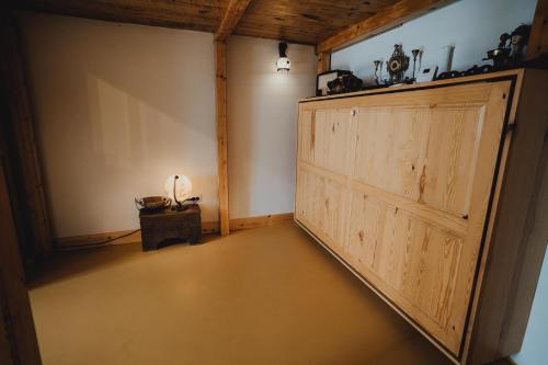 an empty room with a wooden door and a table at The Downtown Nest in Cluj-Napoca