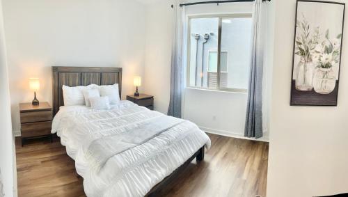 a white bedroom with a large bed and a window at Casa Dolce Vita - Luxury Modern Stays - Flexible Monthly Arrangements Available 30-Night Minimum in Irvine