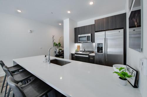 a kitchen with a white counter top and a refrigerator at River West Red Peak Condo - Sweet Summit Retreat in Silverthorne
