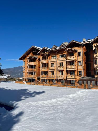 a large building with an ice rink in front of it at Allure in Pirin Golf in Razlog