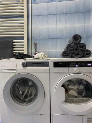two washing machines and a washer and dryer in a room at Belgrade centrum in Karaburma