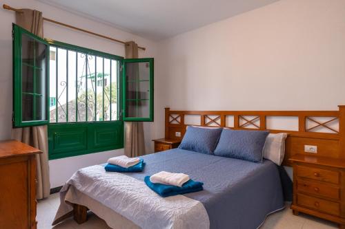 a bedroom with a bed with two towels on it at Casa Martín in Puerto del Carmen