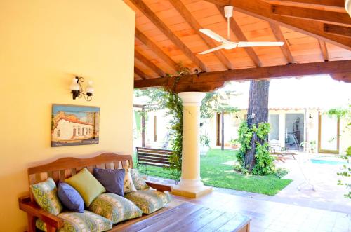 a living room with a couch under a wooden ceiling at La Casona Hotel Boutique in Asuncion