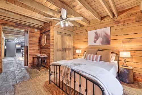 a bedroom with a bed in a room with wooden walls at Charming Jeffersonville Barndominium with Fire Pit! in Jeffersonville