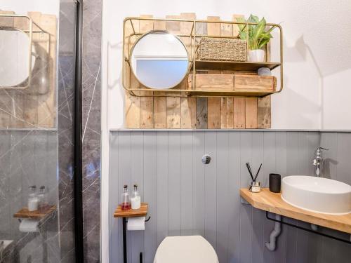 a bathroom with a sink and a mirror at Appledore Cottage in Farnham