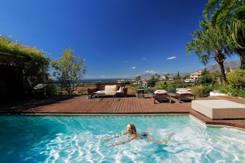 a woman is laying in a swimming pool at Marbella Boutique Art hotel in Marbella