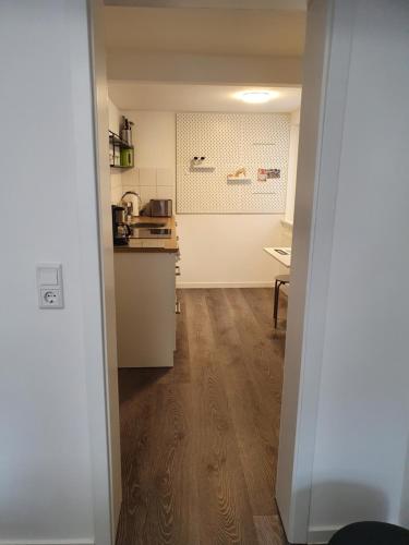 an open door to a kitchen with a counter at QUELLQUARTIER in Fulda