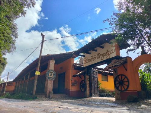 a building with a sign in front of it at Cabañas y habitaciones Los Cedros in Zacatlán