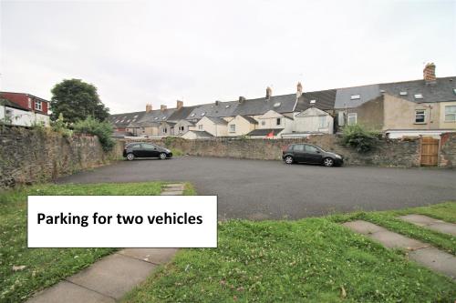 a street with two cars parked on the road at Thesiger Court Apartments - Free Private Parking - by Property Promise in Cardiff
