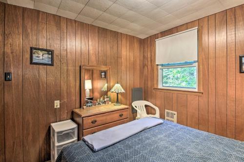 a bedroom with a bed and a dresser and a window at Raymond Retreat with 200 Feet of Private Beach! in Raymond