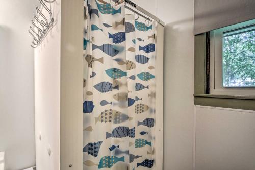 a shower curtain in a bathroom with a window at Raymond Retreat with 200 Feet of Private Beach! in Raymond