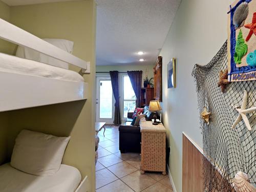 a room with two bunk beds and a living room at Grand Caribbean Perdido Key #407 West in Perdido Key