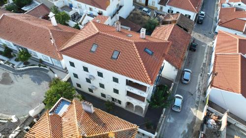 an overhead view of a large white building with red roofs at Casa Da Planicie in Reguengos de Monsaraz