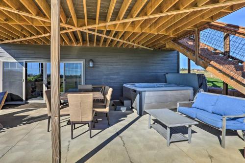a patio with a table and chairs and a blue couch at Black Hills Retreat about 3 Mi to ATV Trails! in Piedmont