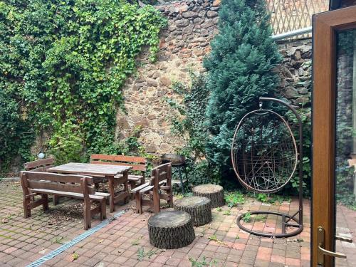 a patio with a wooden table and two benches at Thermal Apartments in Teplice