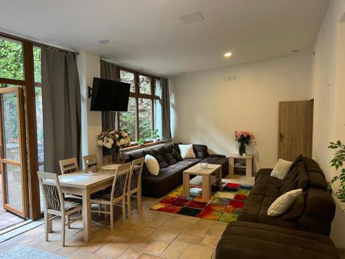 a living room with a couch and a table at Thermal Apartments in Teplice