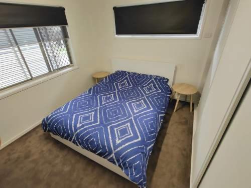 a small bedroom with a bed and a window at 321 Milton in Brisbane