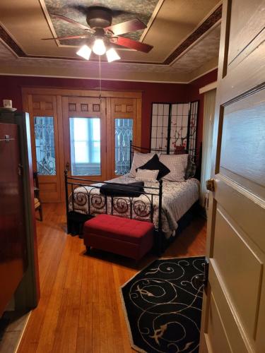 a bedroom with a bed and a ceiling fan at Prairie House Manor Bed and Breakfast in De Smet