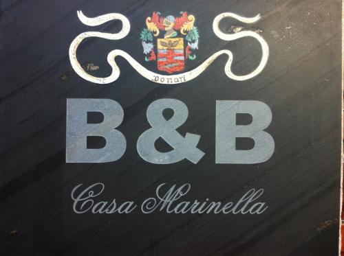 a sign for a restaurant with a b logo at Bed & Breakfast Casa Marinella in Lenna