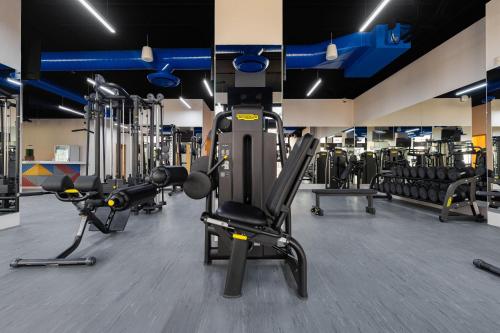 a gym with several treadmills and machines at Villa La Valencia Beach Resort & Spa Los Cabos in San José del Cabo