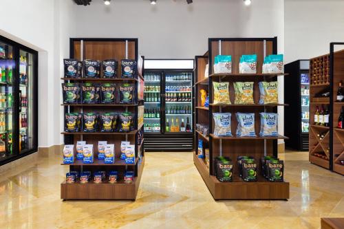 a store aisle with shelves of food and drinks at Villa La Valencia Beach Resort & Spa Los Cabos in San José del Cabo