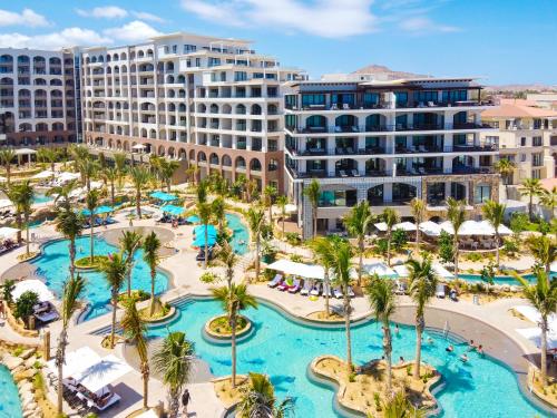 an aerial view of a resort with palm trees and pools at Villa La Valencia Beach Resort & Spa Los Cabos in San José del Cabo
