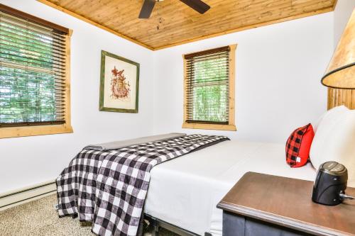 a bedroom with a bed and two windows at The Nut House in Eagle River