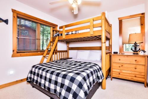 a bedroom with a bunk bed and a ladder at The Loons Nest in Eagle River