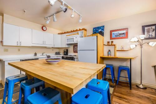 a kitchen with a wooden table and blue chairs at Mountainside Condo #307 in Girdwood