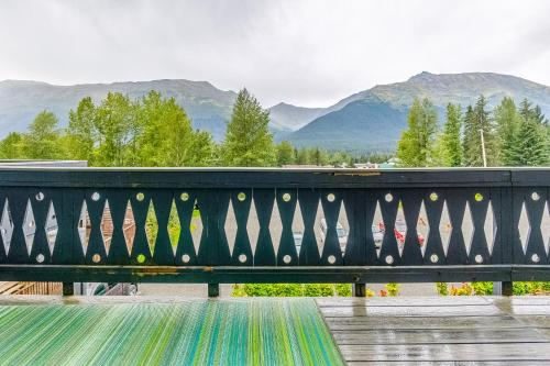 a black railing with mountains in the background at Mountainside Condo #307 in Girdwood
