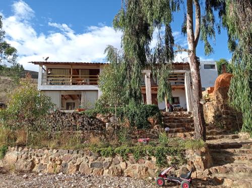 a house sitting on top of a rocky hill at Villa Aventura Lodge in Cajamarca