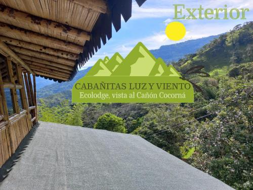 a view of a mountain from a building with the words cámias luxury at Cabaña LuzMi Cocorná in Cocorná