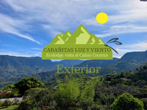 a sign for a valley with a mountain in the background at Cabaña LuzMi Cocorná in Cocorná