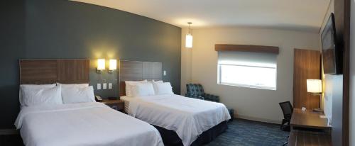a hotel room with two beds and a window at Holiday Inn Express & Suites Mexicali by IHG in Mexicali
