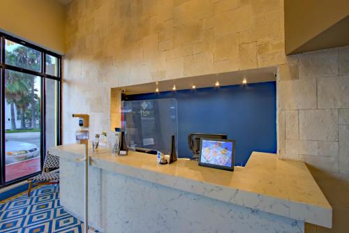 a lobby with a stone wall and a reception counter at La Pinta Hotel in Ensenada