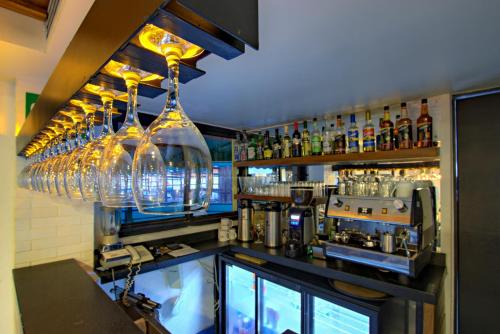 a bar with a bunch of glasses on the wall at La Pinta Hotel in Ensenada