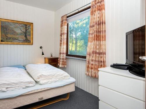 a bedroom with a bed and a window at 6 person holiday home in Ørsted-By Traum in Ørsted