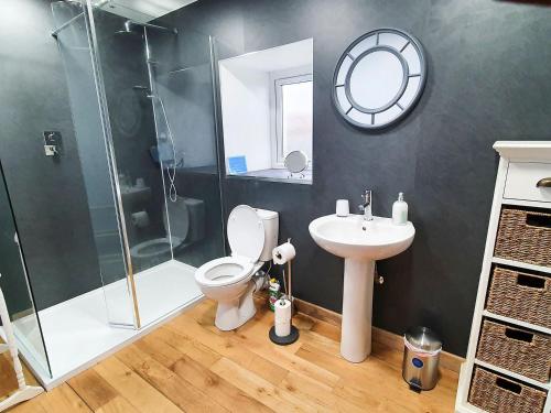 a bathroom with a shower and a toilet and a sink at Ethels House in Armadale