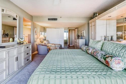 a bedroom with a large bed and a kitchen at Landmark Towers 203 in Clearwater Beach