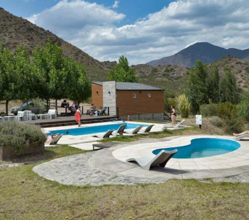 a large swimming pool with people standing around it at Entre Montañas in Potrerillos