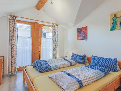 1 dormitorio con 2 camas y ventana en Penthouse Petra, en Brixen im Thale