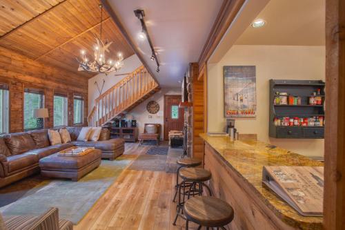 a living room with a couch and a bar at Aspencliffe Home: Perfect Mountain Getaway w/ Hot Tub in Blue River